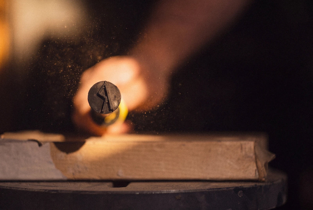 Runewood branding iron marking a handcrafted wooden board