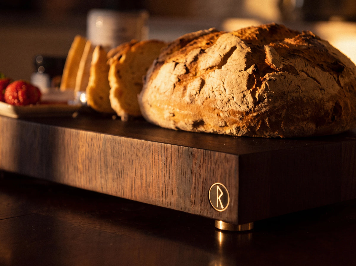 Finished Runewood wooden board with brass feet used for serving bread